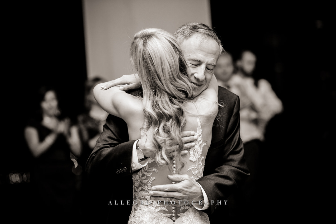 bride hugs father of the bride in black and white